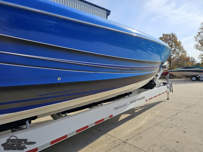 Slide: The Image of 2008 Outerlimits 46 Limited boat on trailer, blue hull, outdoor setting. - 13