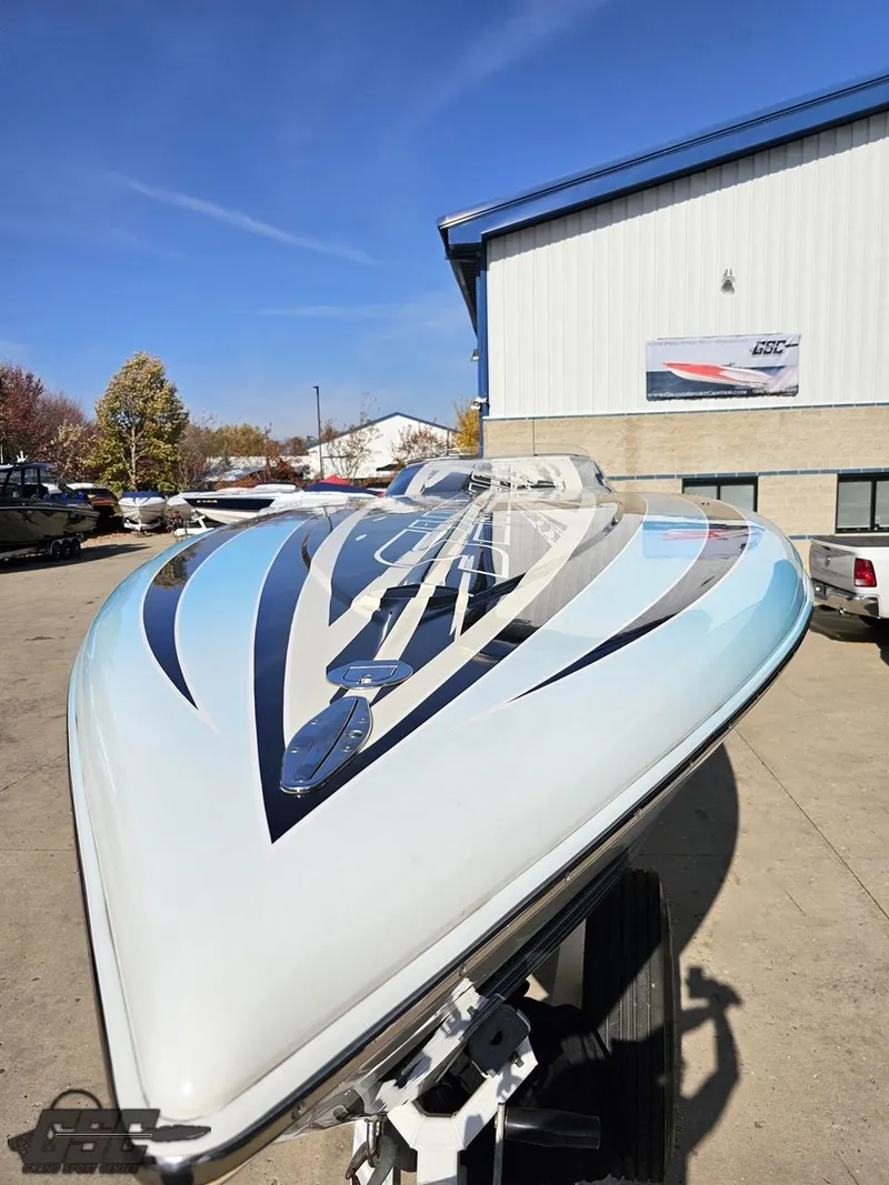 Slide: The Image of 2008 Outerlimits 46 Limited speedboat with sleek design, parked outdoors. - 17