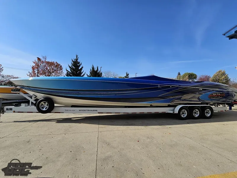 Slide: The Image of 2008 Outerlimits 46 Limited speedboat on trailer, blue and silver design, parked outdoors. - 21