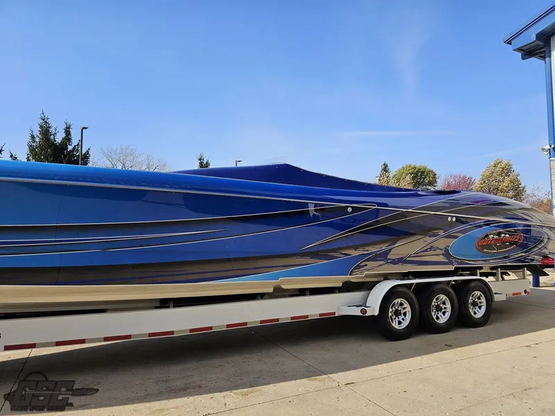 Slide: The Image of 2008 Outerlimits 46 Limited speedboat on trailer, sleek blue design. - 26