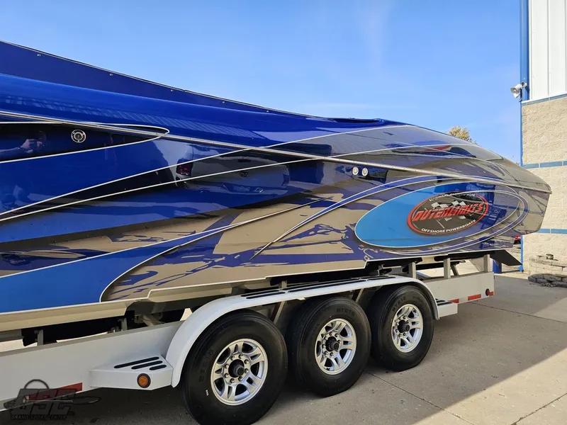 Slide: The Image of 2008 Outerlimits 46 Limited boat with blue and silver design on a trailer. - 28