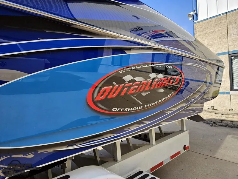 Slide: The Image of 2008 Outerlimits 46 Limited powerboat with blue and silver detailing on a trailer. - 29