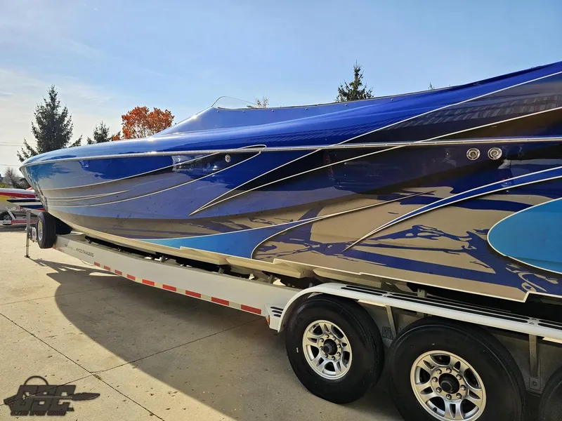 Slide: The Image of 2008 Outerlimits 46 Limited speedboat with sleek blue design on a trailer. - 31