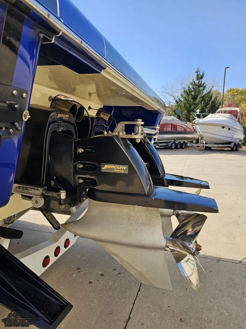 Slide: The Image of 2008 Outerlimits 46 Limited boat with Mercury outdrives, docked outdoors. - 38