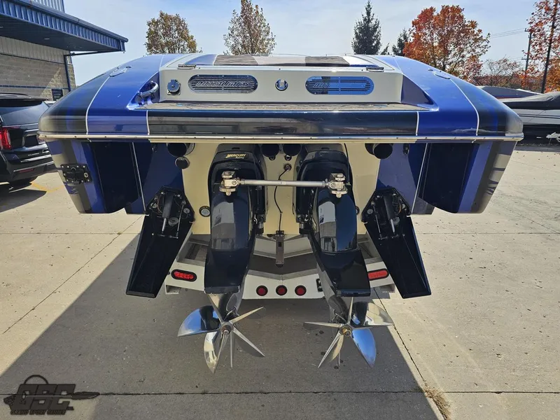 Slide: The Image of 2008 Outerlimits 46 Limited boat with dual propellers, parked outdoors. - 39