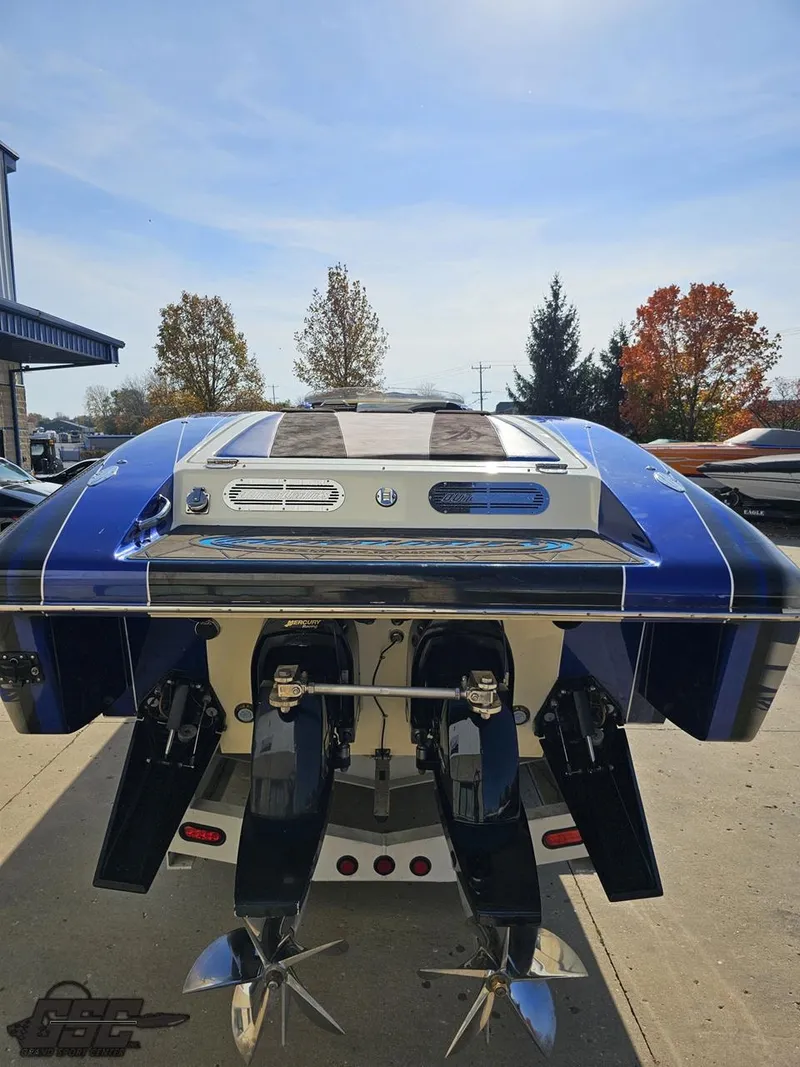 Slide: The Image of 2008 Outerlimits 46 Limited speedboat, rear view with dual propellers, parked outdoors. - 40