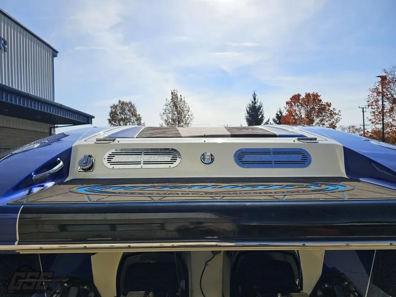 Slide: The Image of 2008 Outerlimits 46 Limited boat, rear view, sleek design, blue and white color scheme. - 44