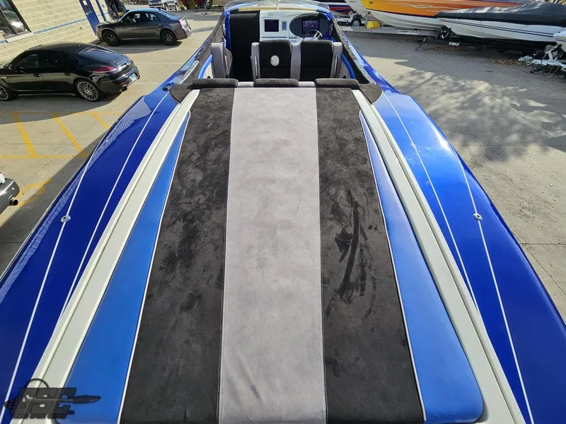 Slide: The Image of 2008 Outerlimits 46 Limited boat with blue and gray upholstery, docked in a marina. - 46