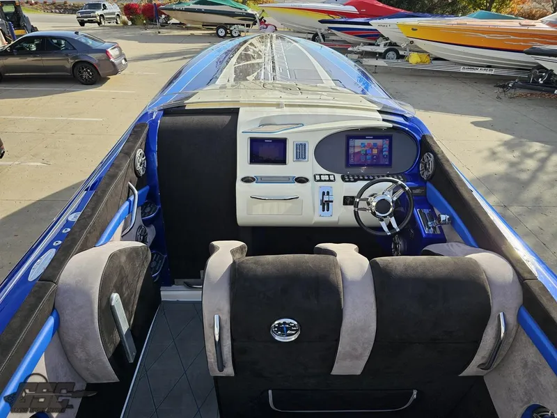 Slide: The Image of 2008 Outerlimits 46 Limited boat interior with modern dashboard and seating. - 49