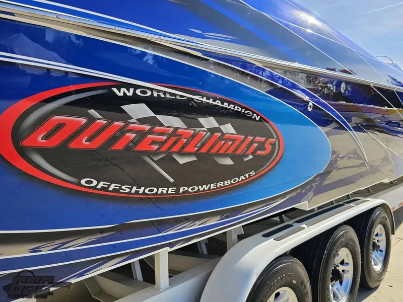 Slide: The Image of 2008 Outerlimits 46 Limited powerboat with vibrant blue and red graphics on trailer. - 7