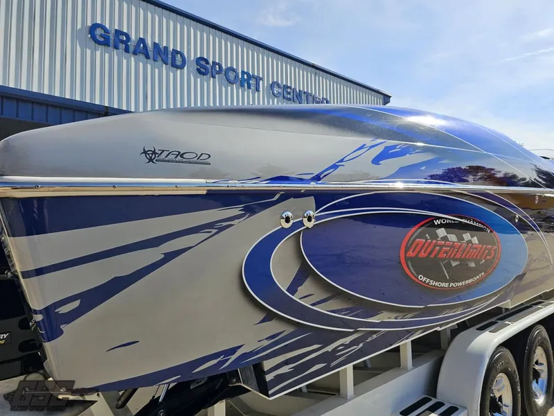 Slide: The Image of 2008 Outerlimits 46 Limited powerboat at Grand Sport Center, featuring sleek blue and silver design. - 8