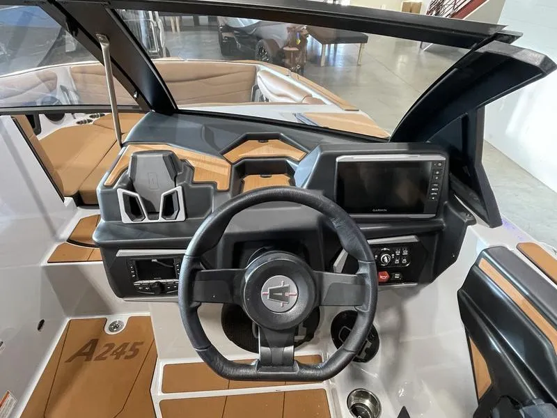 Slide: The Image of 2025 Axis A245 boat dashboard with steering wheel and digital display. - 15