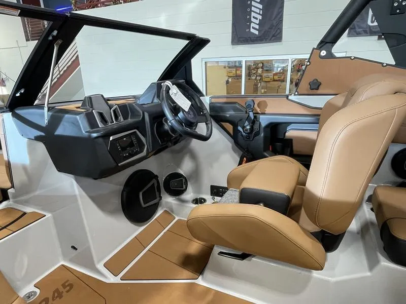 Slide: The Image of 2025 Axis A245 boat interior with tan seats and modern dashboard. - 16