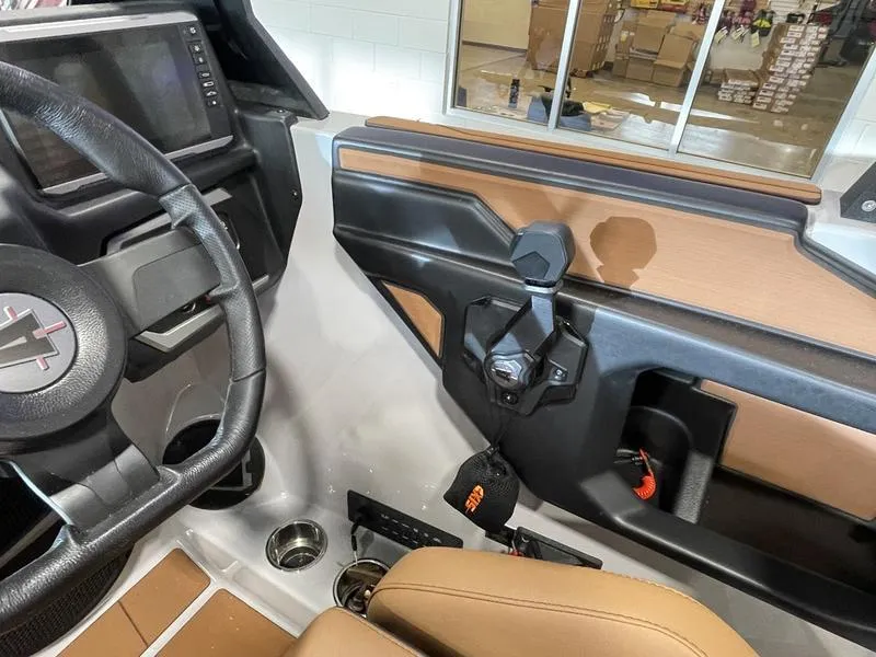 Slide: The Image of 2025 Axis A245 boat interior with steering wheel and control panel. - 17