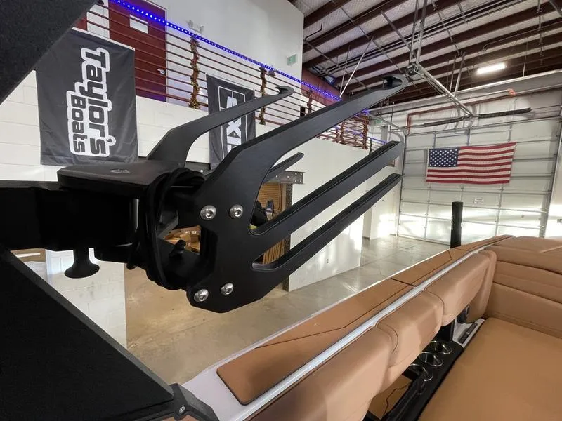 Slide: The Image of Axis A245 2025 boat interior with wakeboard rack, American flag in background. - 22