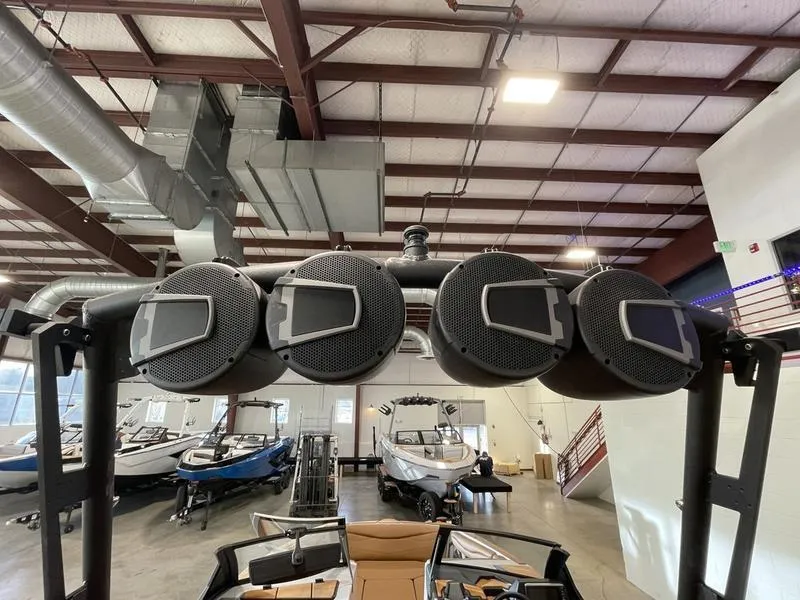 Slide: The Image of 2025 Axis A245 boat speakers in showroom with other boats. - 23