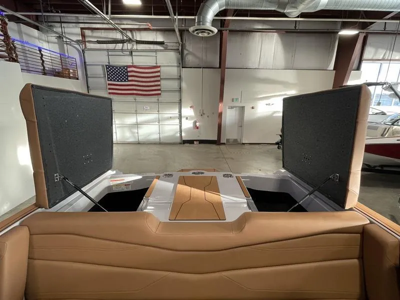 Slide: The Image of 2025 Axis A245 boat interior with open storage compartments in a showroom. - 24