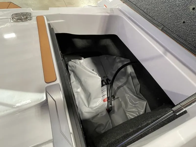 Slide: The Image of Axis A245 2025 boat storage compartment with ballast bag and hose. - 26