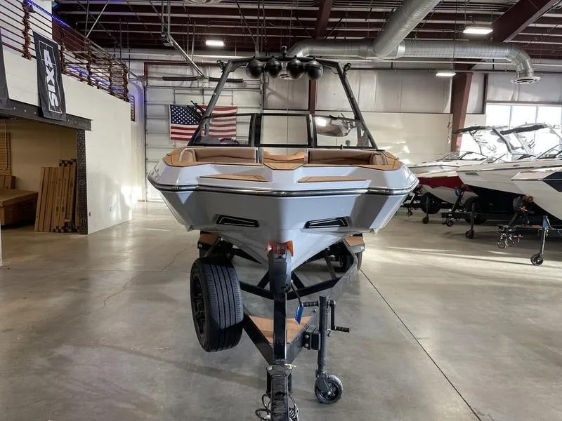 Slide: The Image of 2025 Axis A245 boat in showroom, front view, on trailer. - 4