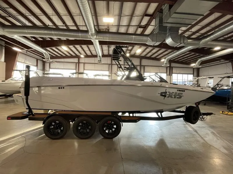 Slide: The Image of 2025 Axis A245 boat in showroom, side view, on trailer. - 5