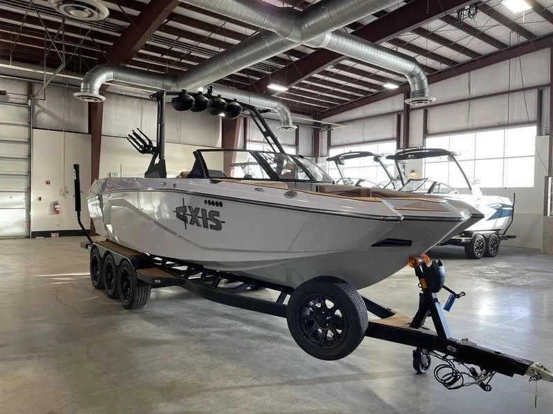 Slide: The Image of 2025 Axis A245 boat on trailer in warehouse setting. - 6