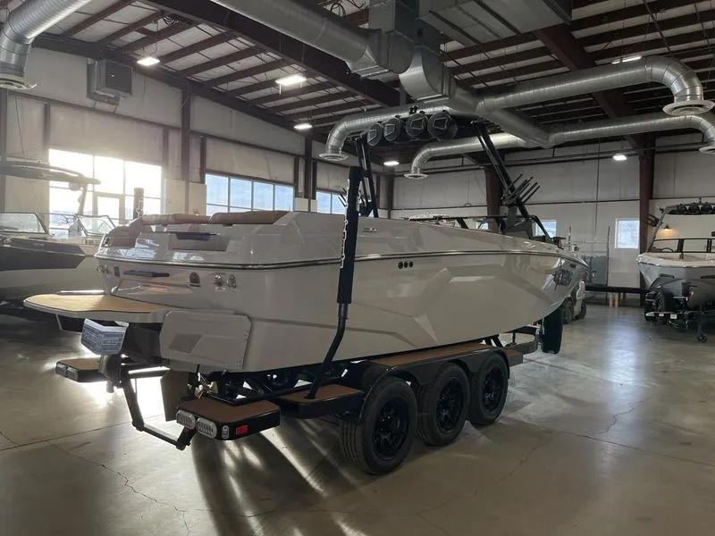 Slide: The Image of 2025 Axis A245 boat on trailer in warehouse setting. - 7