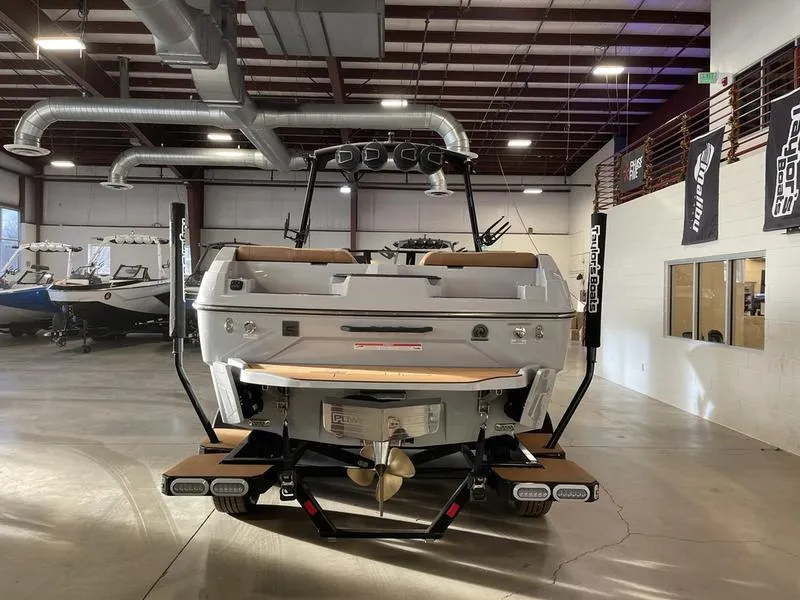 Slide: The Image of 2025 Axis A245 boat in showroom, rear view with propeller and swim platform. - 8