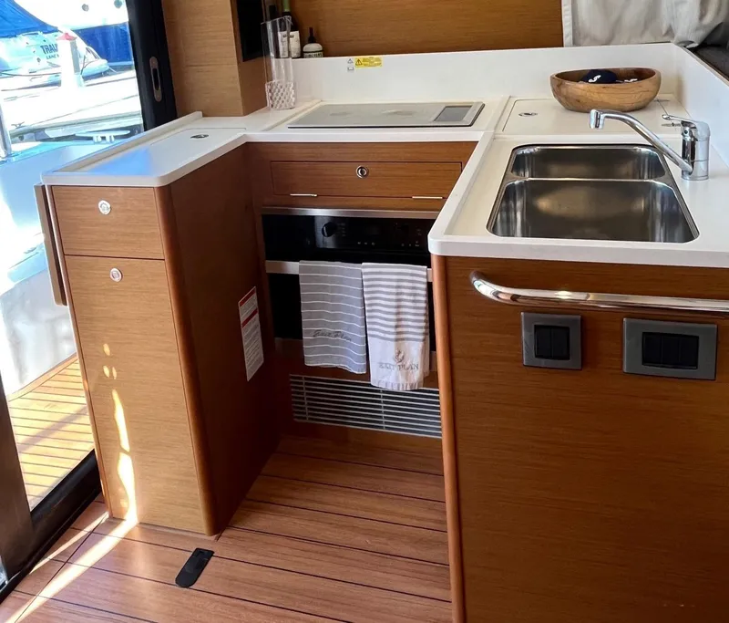 Slide: The Image of Modern kitchen in 2021 Beneteau Swift Trawler 41 with wood finish and stainless steel sink. - 12