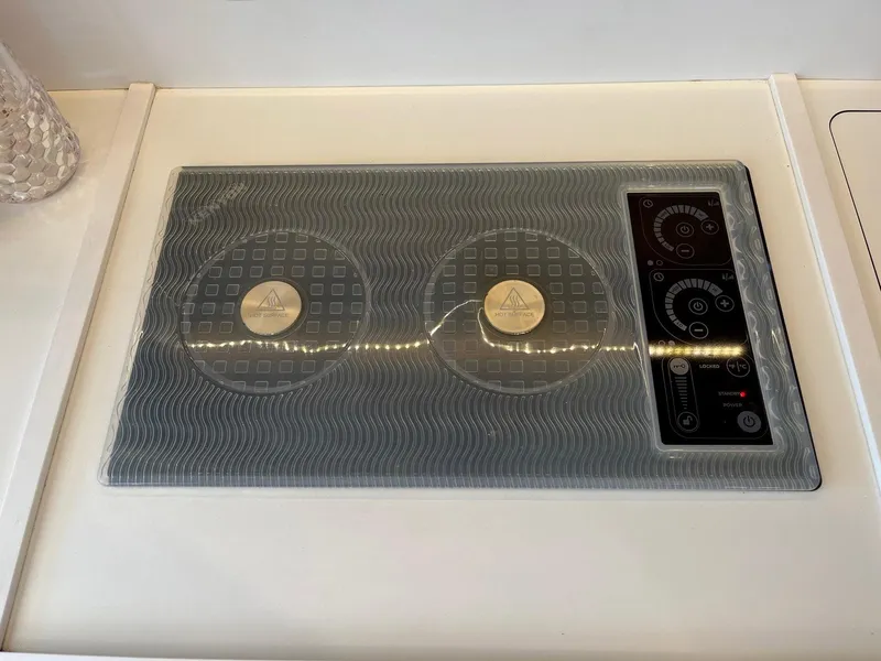 Slide: The Image of Modern stovetop on 2021 Beneteau Swift Trawler 41 yacht kitchen. - 13