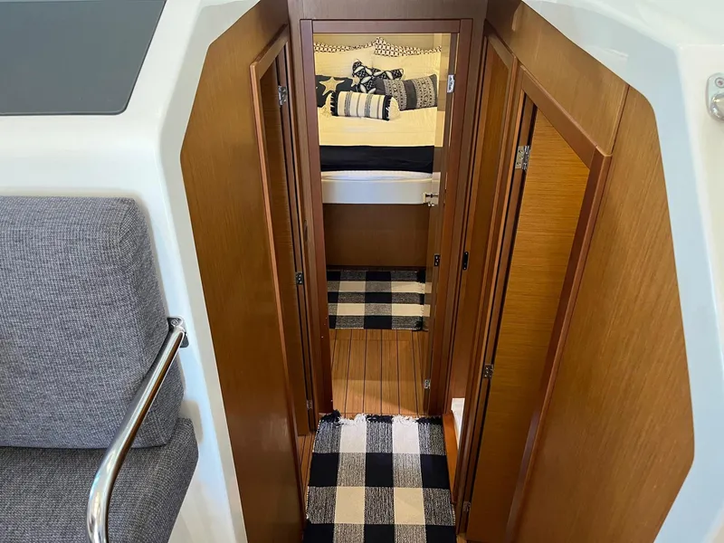 Slide: The Image of Interior of 2021 Beneteau Swift Trawler 41 with cozy cabin and checkered rug. - 21