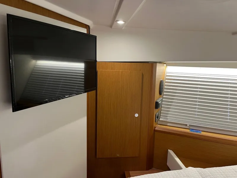 Slide: The Image of Interior of 2021 Beneteau Swift Trawler 41 with TV and wooden paneling. - 22