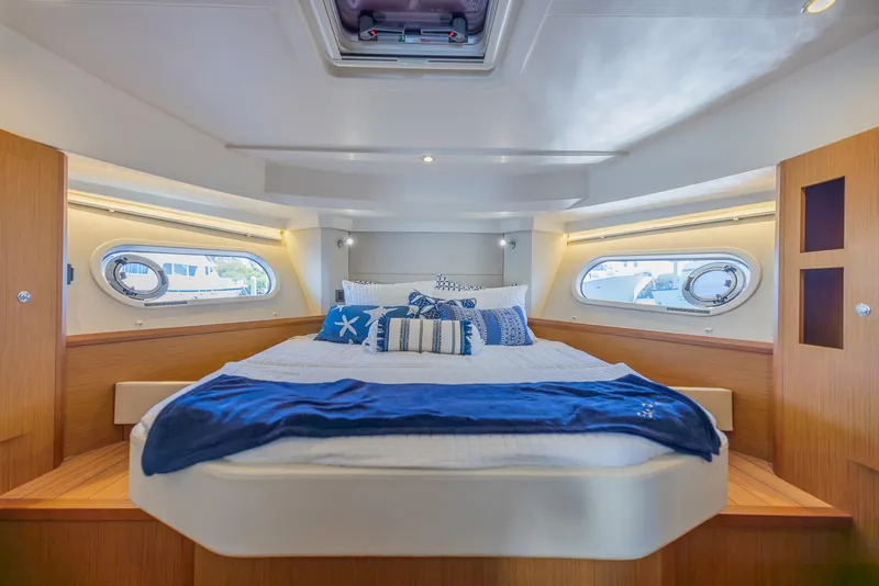 Slide: The Image of Luxurious cabin interior of 2021 Beneteau Swift Trawler 41 with cozy bedding. - 23