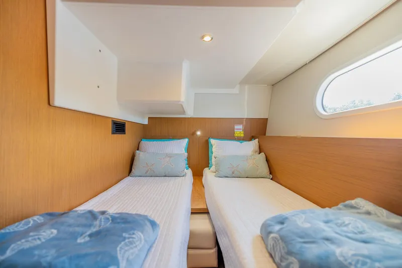 Slide: The Image of Twin cabin interior of 2021 Beneteau Swift Trawler 41 with cozy bedding. - 28