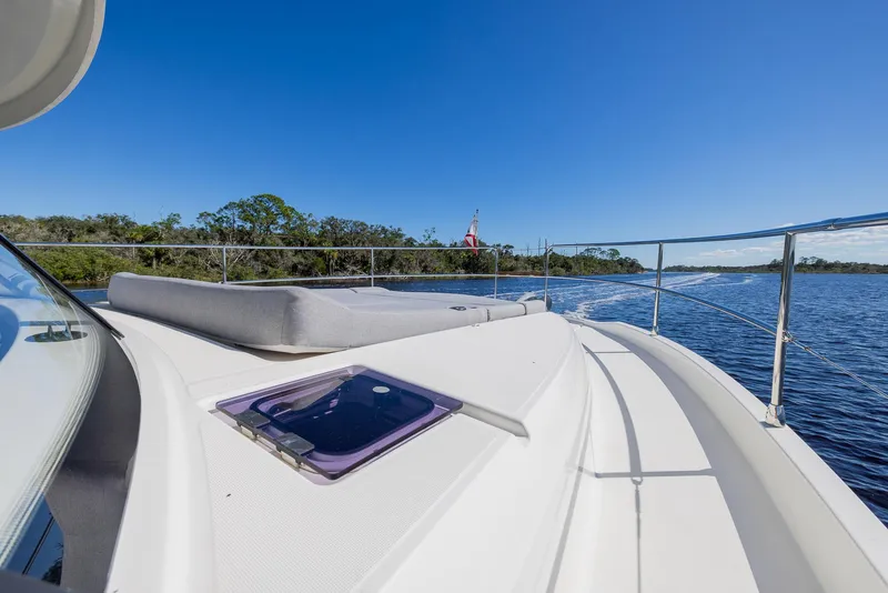 Slide: The Image of 2021 Beneteau Swift Trawler 41 cruising on a sunny day, featuring spacious deck and scenic waterway. - 33