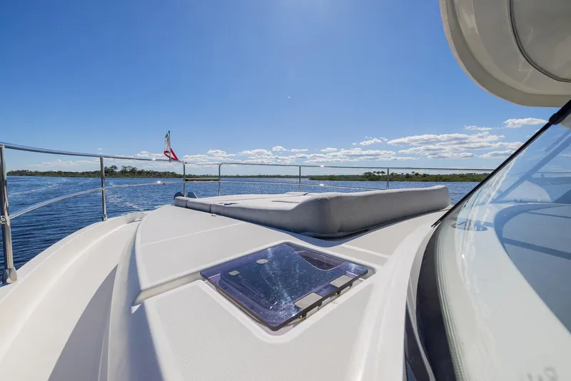 Slide: The Image of 2021 Beneteau Swift Trawler 41 cruising on a sunny day, featuring a spacious deck. - 34
