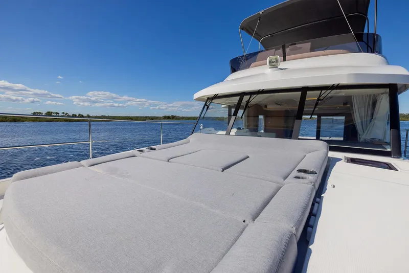 Slide: The Image of 2021 Beneteau Swift Trawler 41 on open water, featuring spacious deck and modern design. - 36