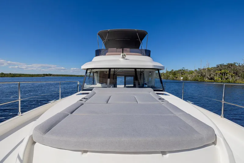 Slide: The Image of 2021 Beneteau Swift Trawler 41 on calm water, featuring spacious deck and sleek design. - 37