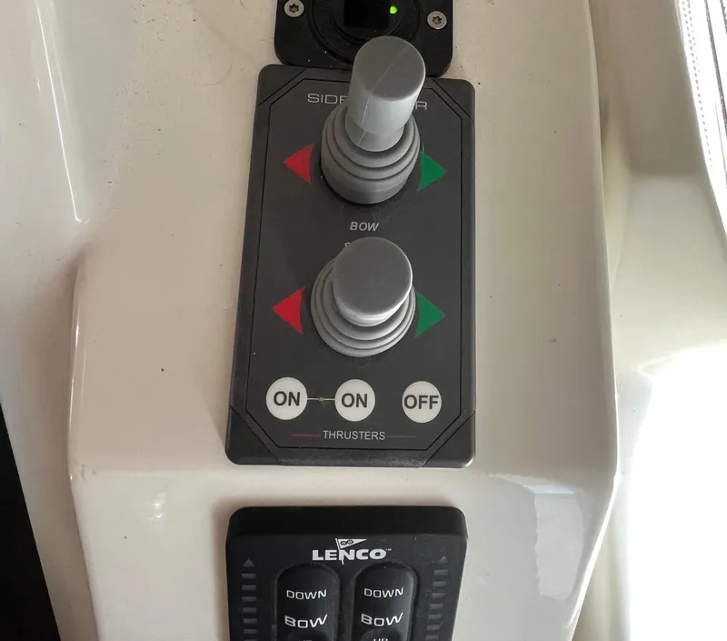 Slide: The Image of Control panel of a 2021 Beneteau Swift Trawler 41, featuring thruster and Lenco controls. - 43