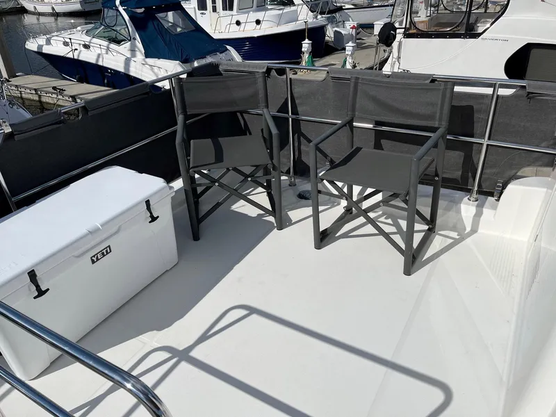 Slide: The Image of Beneteau Swift Trawler 41 deck with chairs and cooler, 2021 model. - 45
