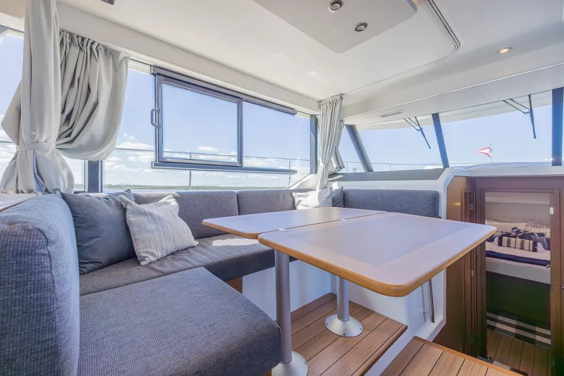 Slide: The Image of Interior of 2021 Beneteau Swift Trawler 41 with modern seating and large windows. - 6