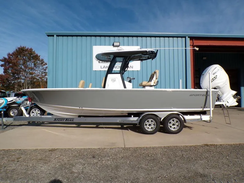 Slide: The Image of 2025 Sportsman Masters 267 boat on trailer outside blue building. - 1