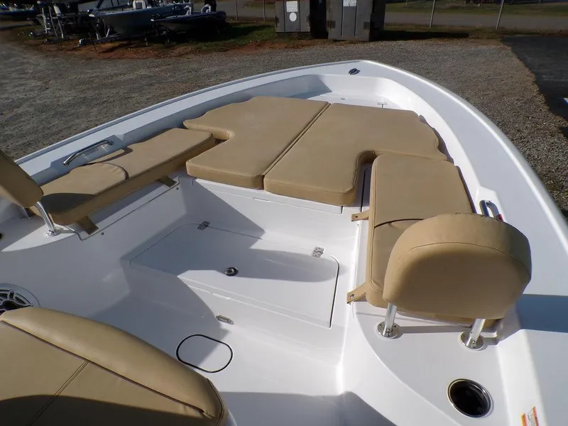 Slide: The Image of 2025 Sportsman Masters 267 boat with beige seating and spacious deck layout. - 12