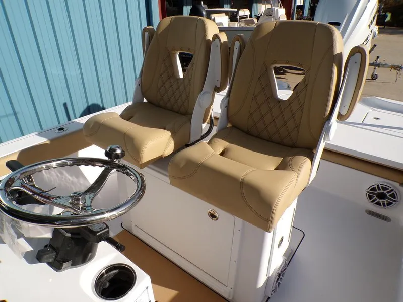 Slide: The Image of 2025 Sportsman Masters 267 boat seats with tan upholstery and steering wheel. - 13