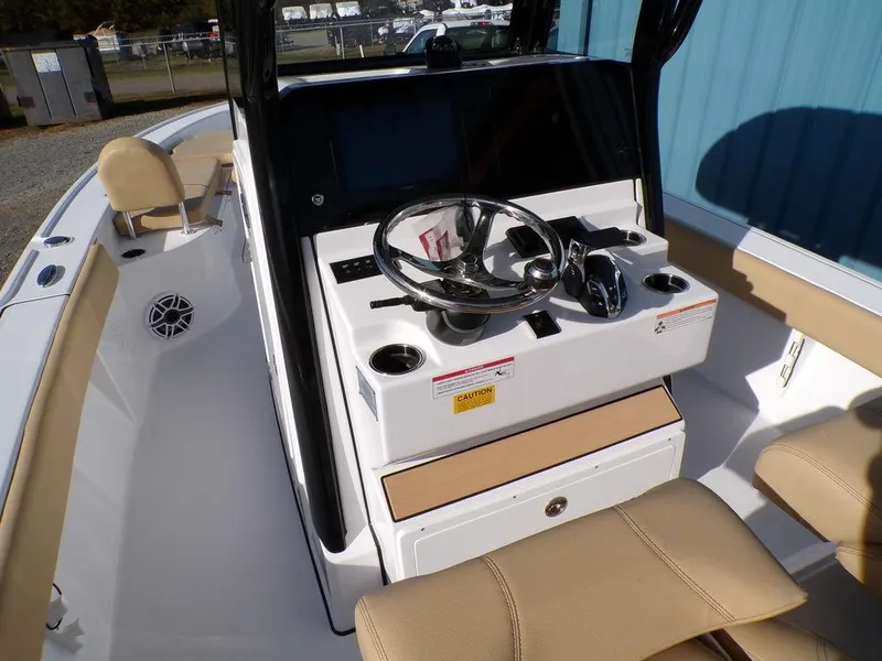 Slide: The Image of 2025 Sportsman Masters 267 boat console with steering wheel and seating. - 16