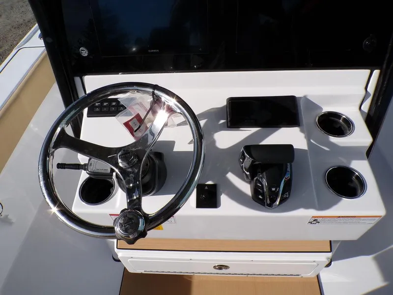 Slide: The Image of 2025 Sportsman Masters 267 boat console with steering wheel and controls. - 18