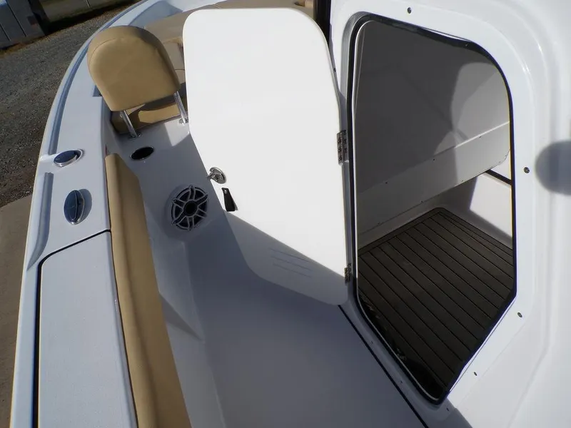 Slide: The Image of 2025 Sportsman Masters 267 boat interior with open storage compartment and seating. - 22
