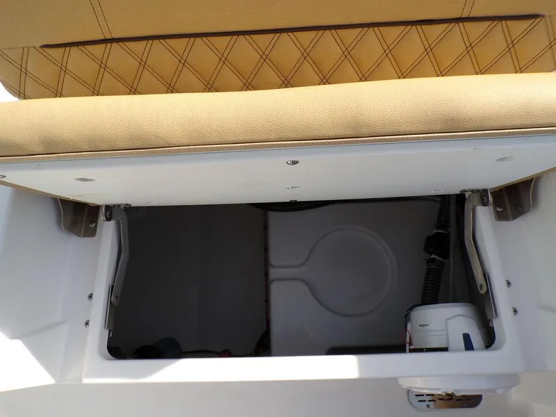 Slide: The Image of Storage compartment in 2025 Sportsman Masters 267 boat with tan cushioned seat. - 36