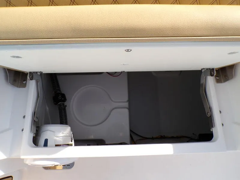 Slide: The Image of 2025 Sportsman Masters 267 boat storage compartment with beige cushioned seating. - 39