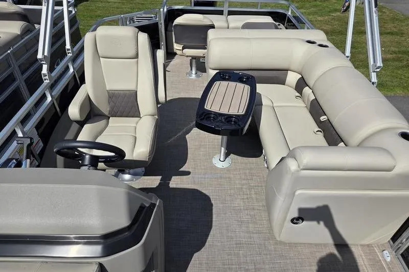 Slide: The Image of 2025 Sun Tracker SF 22 DLX pontoon boat interior with beige seating and table. - 10