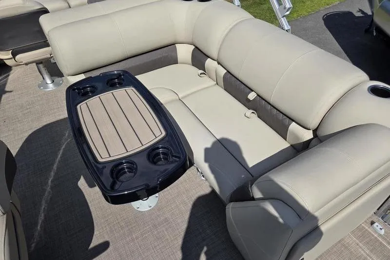 Slide: The Image of 2025 Sun Tracker SF 22 DLX pontoon boat interior with beige seating and table. - 12